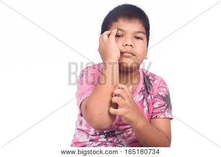 Cute little boy scratch his arm on white background