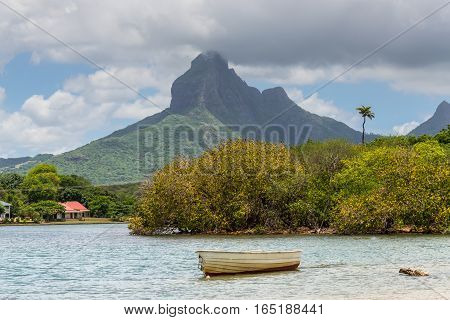 Rempart peak from Tamarin Bay Black River District Mauritius Island. Wooden boat in the foreground.