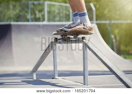 Skater Doing 50-50 Grind On Fun-box In Skatepark