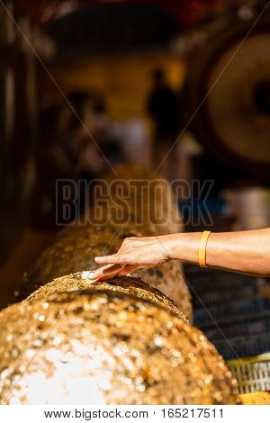 Gold Foil Leaf On Circle Stone In Buddhist Temple Thailand