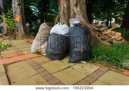 sacks of garbage lay down at pedestrian photo taken in Jakarta Indonesia java