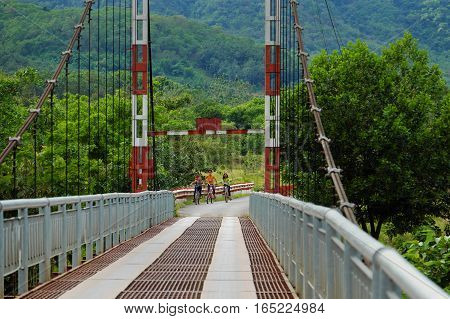 Vietnamese Children Ride Bicycle On Suspension Bridge
