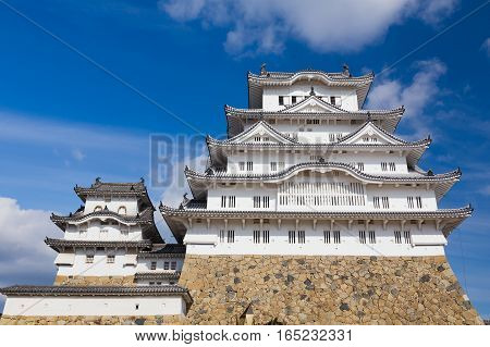 White Heron Castle named Himeji Castle over high hill with blue sky background Japan
