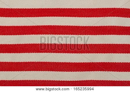 Fabric texture background close-up. Red - white striped color. With copy space for text or image.