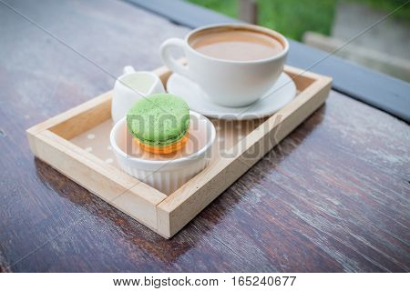 hot coffee breakfast set with fresh macaroon in outdoor bakery house cafe