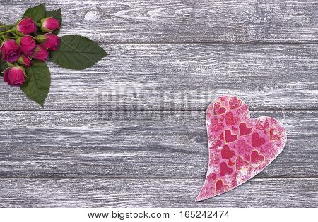 Valentines day background card with pink roses and red heart on gray wooden background. Love. Wedding.