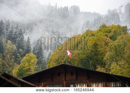 Swiss flag on wood house - stock photo