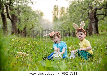 Two Little Kids Boys And Friends In Easter Bunny Ears During Tra