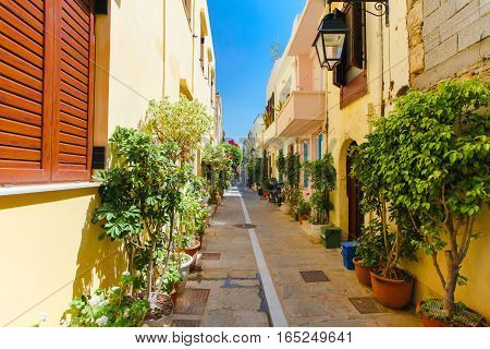 Rethymnon Island Crete Greece - June 23 2016: The narrow street of Rethymnon (part of Old Town) where there are a lot of pots with flowers