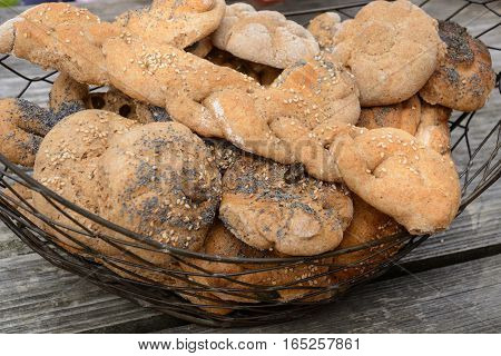 Home-baked whole-grain bread rolls in rusical bread basket