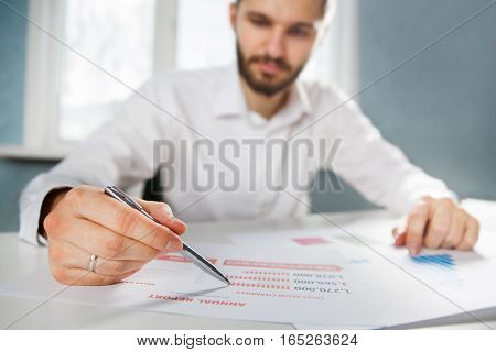 Business person analyzing financial statistics displayed on the tablet