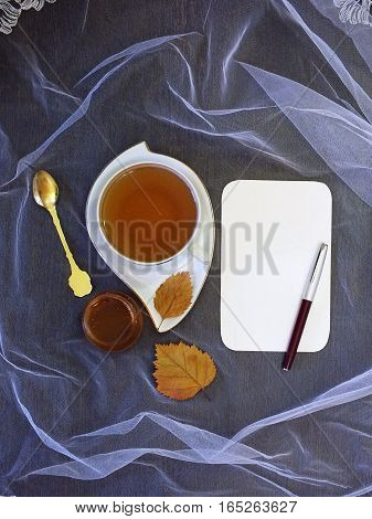 Cup of tea and sheet of paper
