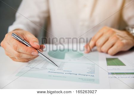 Business person analyzing financial statistics displayed on the tablet