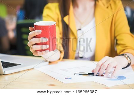 Businesswoman Holding Red Cup Of Coffee On Coffeebreak Time.