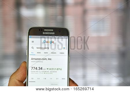 MONTREAL CANADA - DECEMBER 23 2016 : Google Finance page with stock chart and Amazon ticker on Samsung S7 screen.