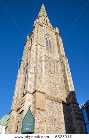 Looking up at the impressive tower of the Lion Walk United Reformed Church in Colchester Essex.