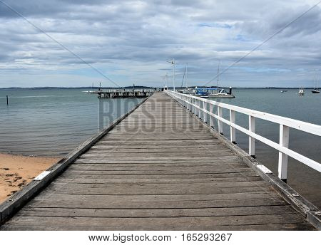 Old wood bridge pier at Rhyll (Philip Island Victoria Australia). Old wooden jetty with natural background.
