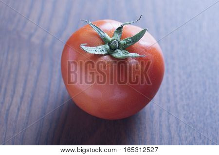 closeup of Red tomato with wooden background