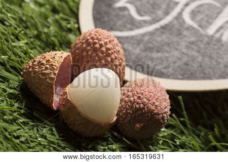 fresh lychees fruit on grass background, closeup