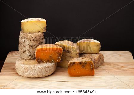 Different kinds of cheese and on a wooden table