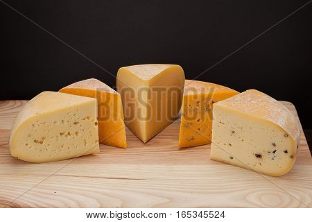 Sliced piece of cheese on a wooden table