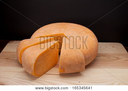 Sliced piece of cheese on a wooden table