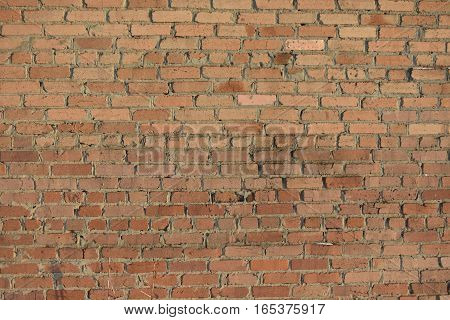 BRICK WALL BUILT OF RED BRICK WITH THE USE OF MODERN TECHNOLOGIES