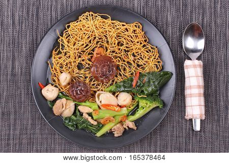 Chinese food ,Crisy  noodle topped kale soup with minced chicken ,mushroom and dried shrimp call Mee Krob Rad Naa.