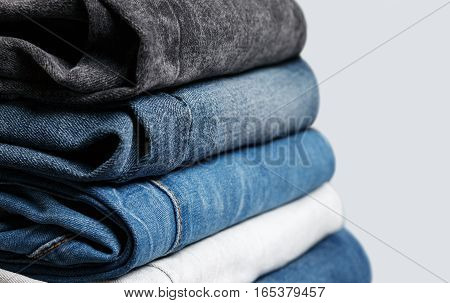 Stack of different jeans up-close. Low aperture shot selective focus