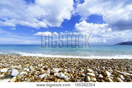Beautiful sea paradise beach on a background of blue sky with clouds.