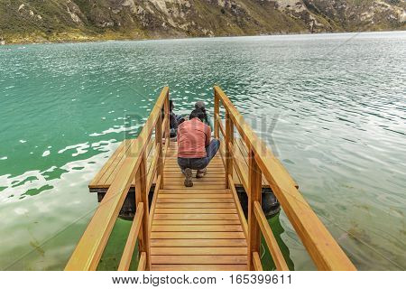 QUILOTOA, ECUADOR, FEBRAURY - 2016 - People at wooden breakwater at Quilotoa lake Latacunga Ecuador