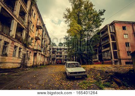 Abandoned mining ghost-town Jantuha, Abkhazia. Destroyed empty houses, the remains of the cars, remnant of The Georgian-Abkhazian war