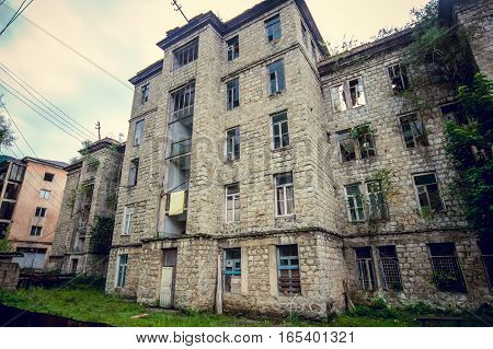 Abandoned mining ghost-town Jantuha, Abkhazia. Destroyed empty houses, the remains of the cars, remnant of The Georgian-Abkhazian war