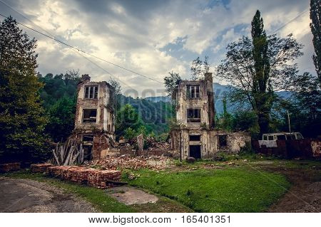 Abandoned mining ghost-town Jantuha, Abkhazia. Destroyed empty houses, the remains of the cars, remnant of The Georgian-Abkhazian war