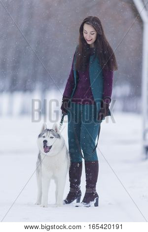 Portrait of Pretty Smiling Woman Walking with Her Dog Outside. Vertical Image Composition