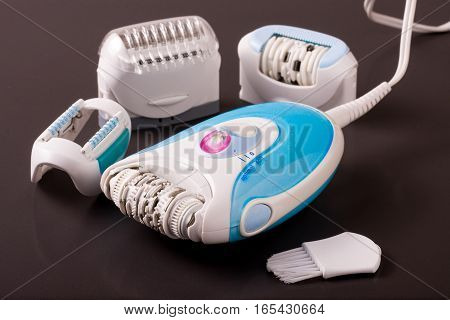 electric epilator or depilator hair on a dark background. Hair removal device