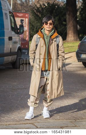 MILAN ITALY - JANUARY 14: Fashionable man poses outside Antonio Marras fashion show building during Milan Men's Fashion Week on JANUARY 14 2017 in Milan.