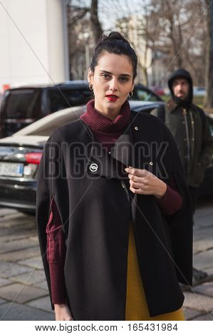 MILAN ITALY - JANUARY 14: Fashionable woman poses outside Antonio Marras fashion show building during Milan Men's Fashion Week on JANUARY 14 2017 in Milan.