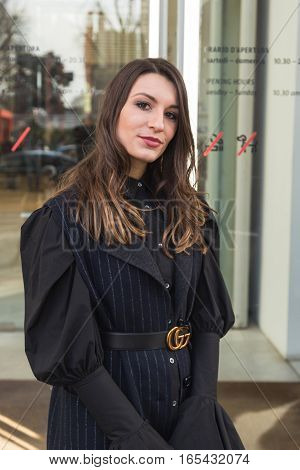 MILAN ITALY - JANUARY 14: Fashionable woman poses outside Antonio Marras fashion show building during Milan Men's Fashion Week on JANUARY 14 2017 in Milan.