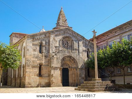 Stone cross in front of the church Colegiata de Santa María del Campo in La Coruna, Galicia, Spain