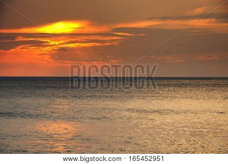 The sands of Mai khao beach in Talang city on Phuket Island thailand overlooking the andaman sea at sunset.