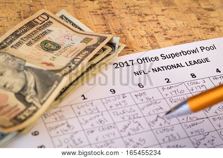 2017 Office Superbowl Pool grid and money pile on cork board