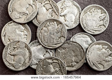A collection of old circulated buffalo nickels.