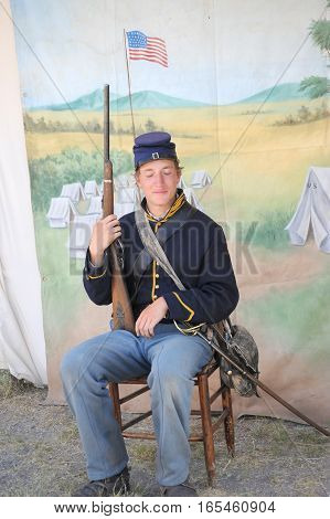 JULY 24, 2015. CASPER, WYOMING. CIRCA: Young calvary reenactor military male recruit posing for the camera outdoors at the annual pioneer day in Casper.