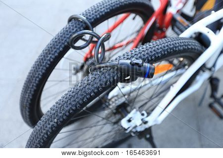 closeup of two bikes locked together for security