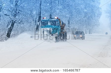snow plow doing snow removal during blizzard