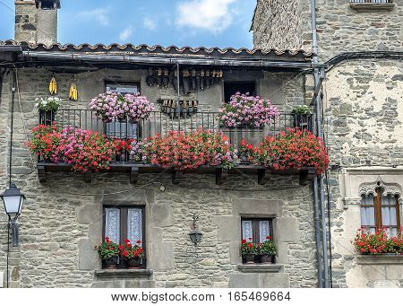 Spain Catalonia . Rupit - medieval mountain village built on top of the basalt rocks in the national park of volcanic origin. The colorful balconies locals.