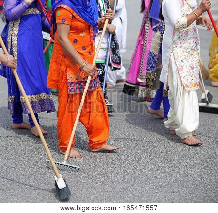Barefoot Women Of Sikh Religion With Colorful Clothes Sweep The