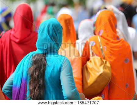 Woman With Long Black Hair Wearing Blue Veil Headdress And A Lon