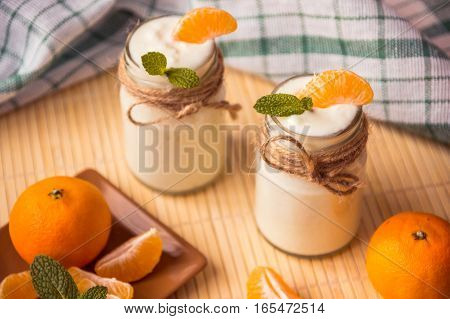 Fresh Organig Natural White Yogurt In Glass Jars With Tangerine And Mint